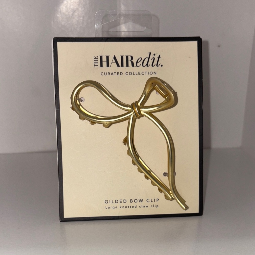 Large, gold, knotted bow clip